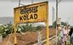 Kolad_a sign on a pole on a dirt road